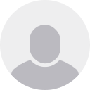 Generic grey user profile silhouette on a light grey circular background.